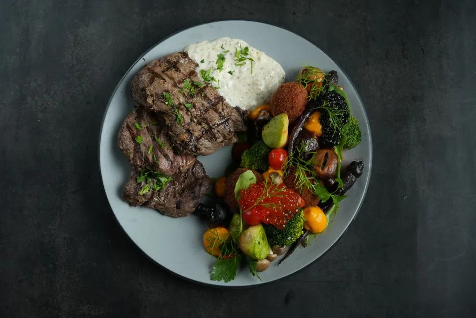 Grilled beef entree on a plate, illustrative photo